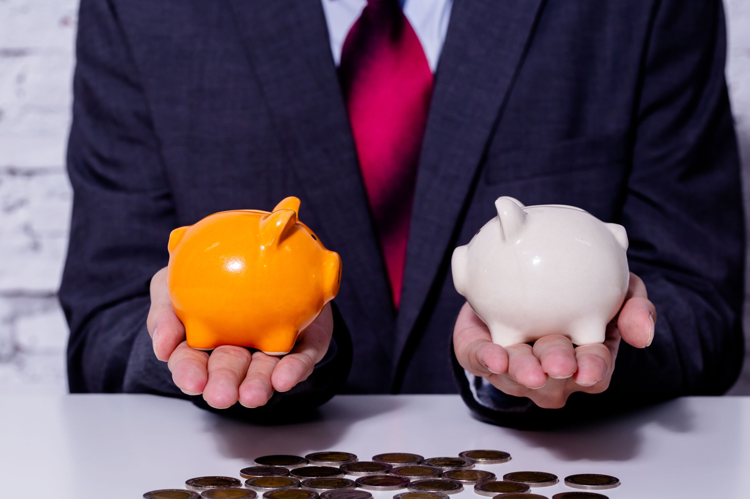An image of a man holding two different piggy banks? This represents the question; Solar Financing or Leasing?