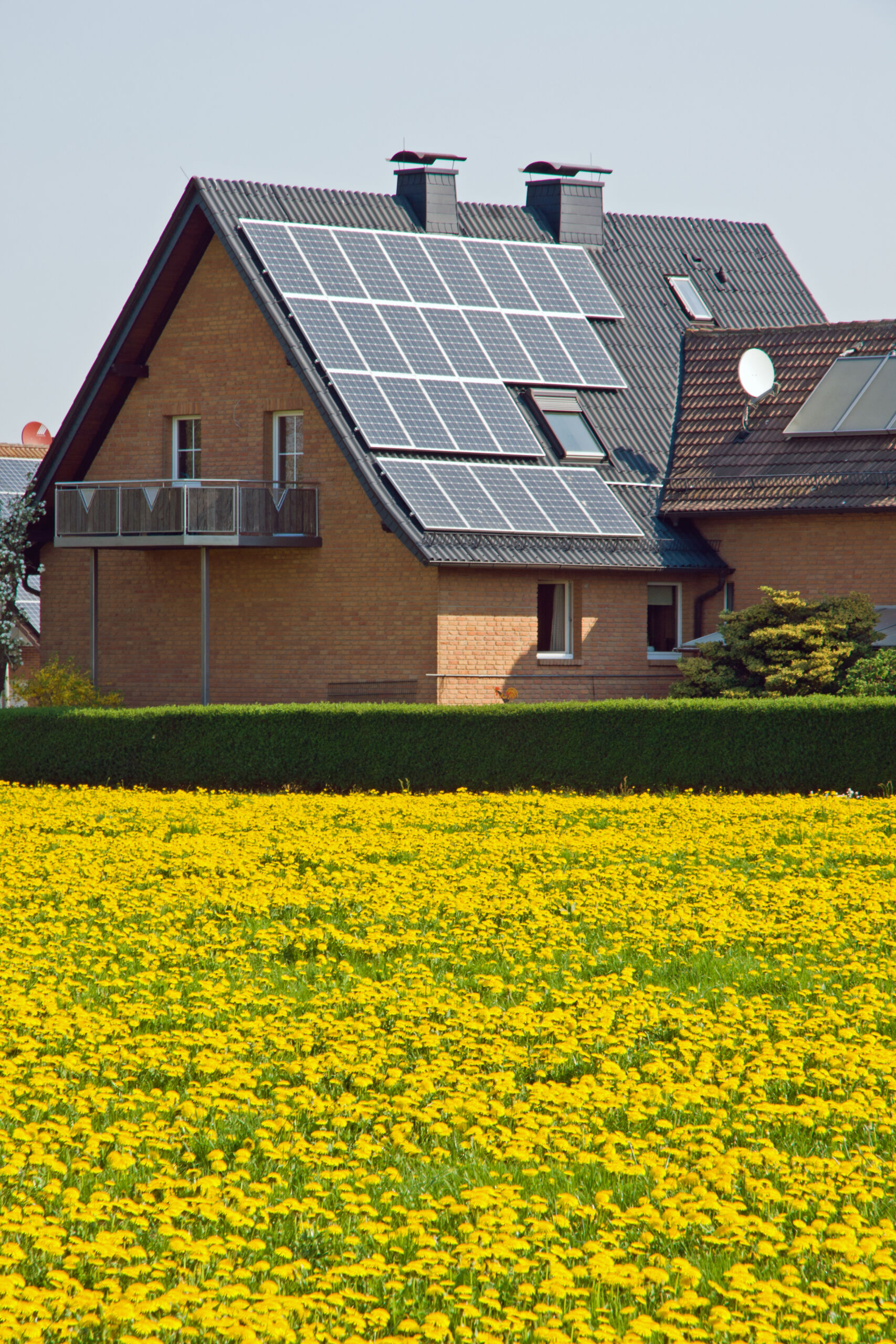 An image of a home with solar panels on the roof. Is solar a scam?