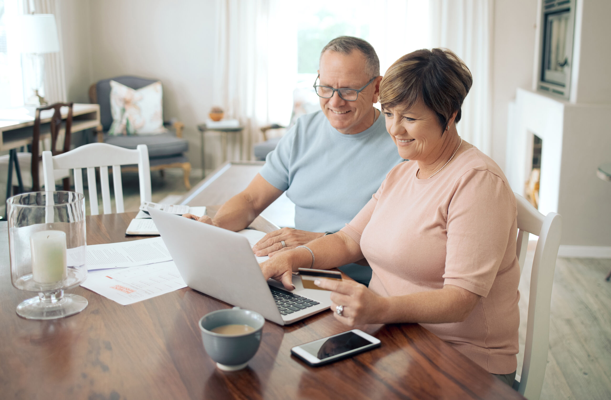 An image of a middle aged couple checking out their savings with solar. How solar financing works. 